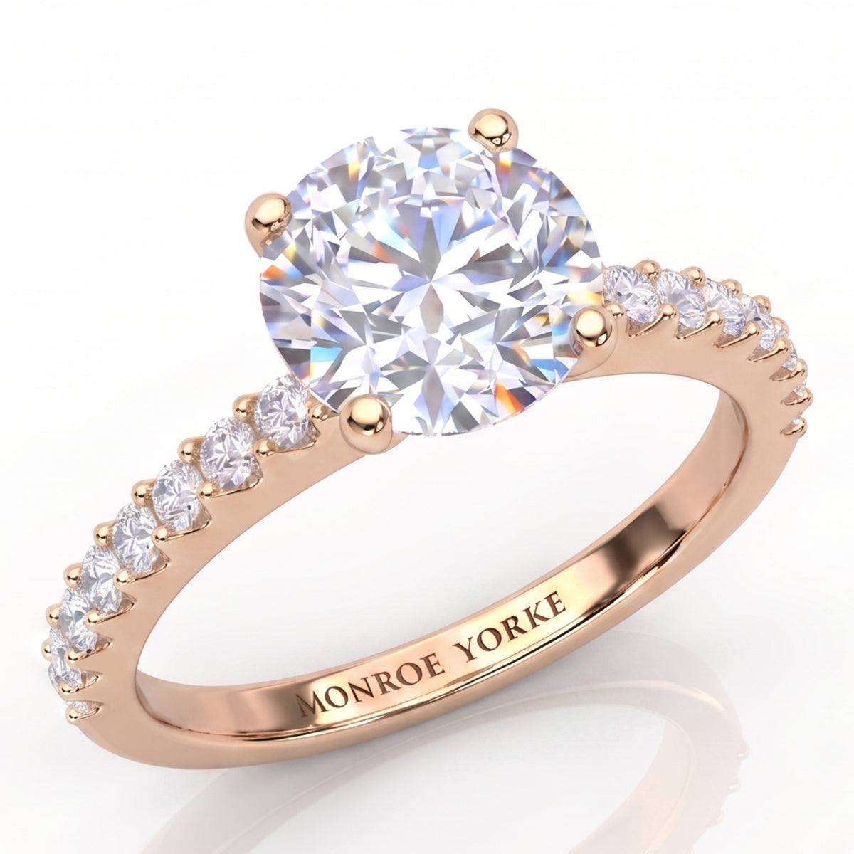 Spring - Rose gold diamond engagement ring with a round brilliant-cut center diamond in a 4 claw setting and pavé-set accent stones on the band.