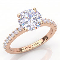Spring - Rose gold diamond engagement ring with a round brilliant-cut center diamond in a 4 claw setting and pavé-set accent stones on the band.