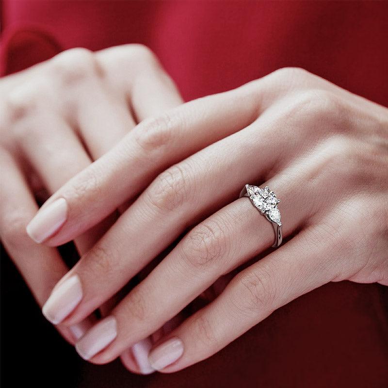 Adele - Three diamond ring.  Three stone ring.  Centre round diamond and two pear cut diamonds.  