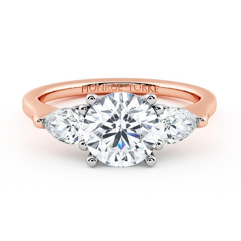 Adele - rose gold diamond trilogy ring.  Centre round diamond and pear cut diamonds on the side.  