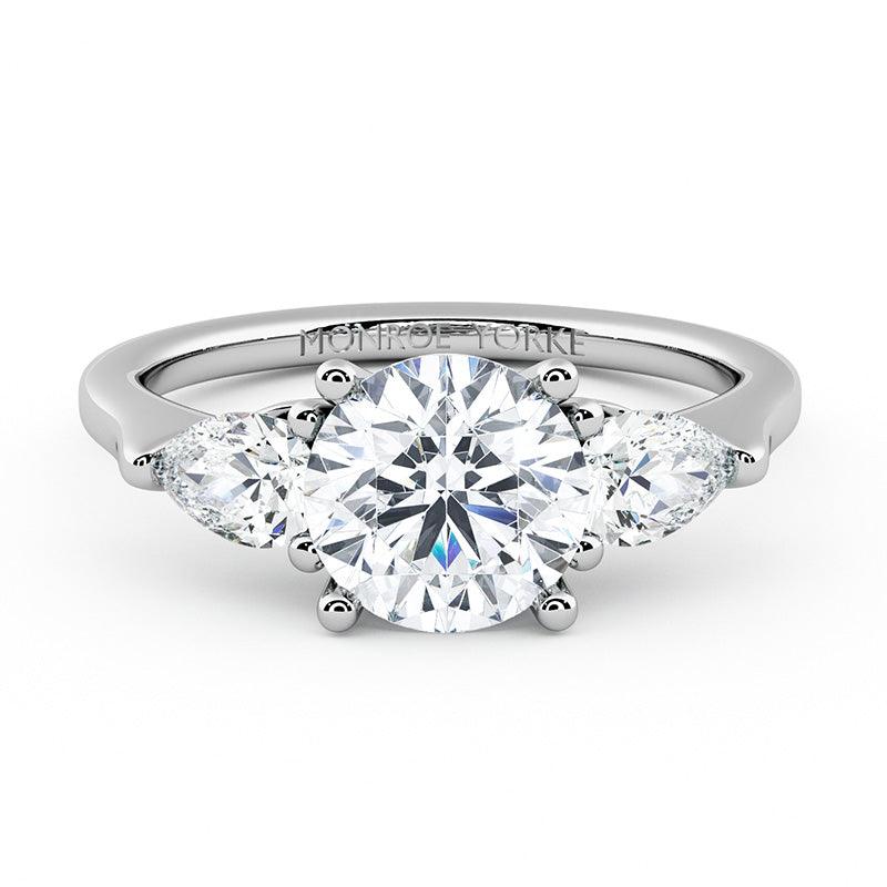 Adele - diamond trilogy ring with round centre diamond and pear cut diamonds.  18ct white gold. 