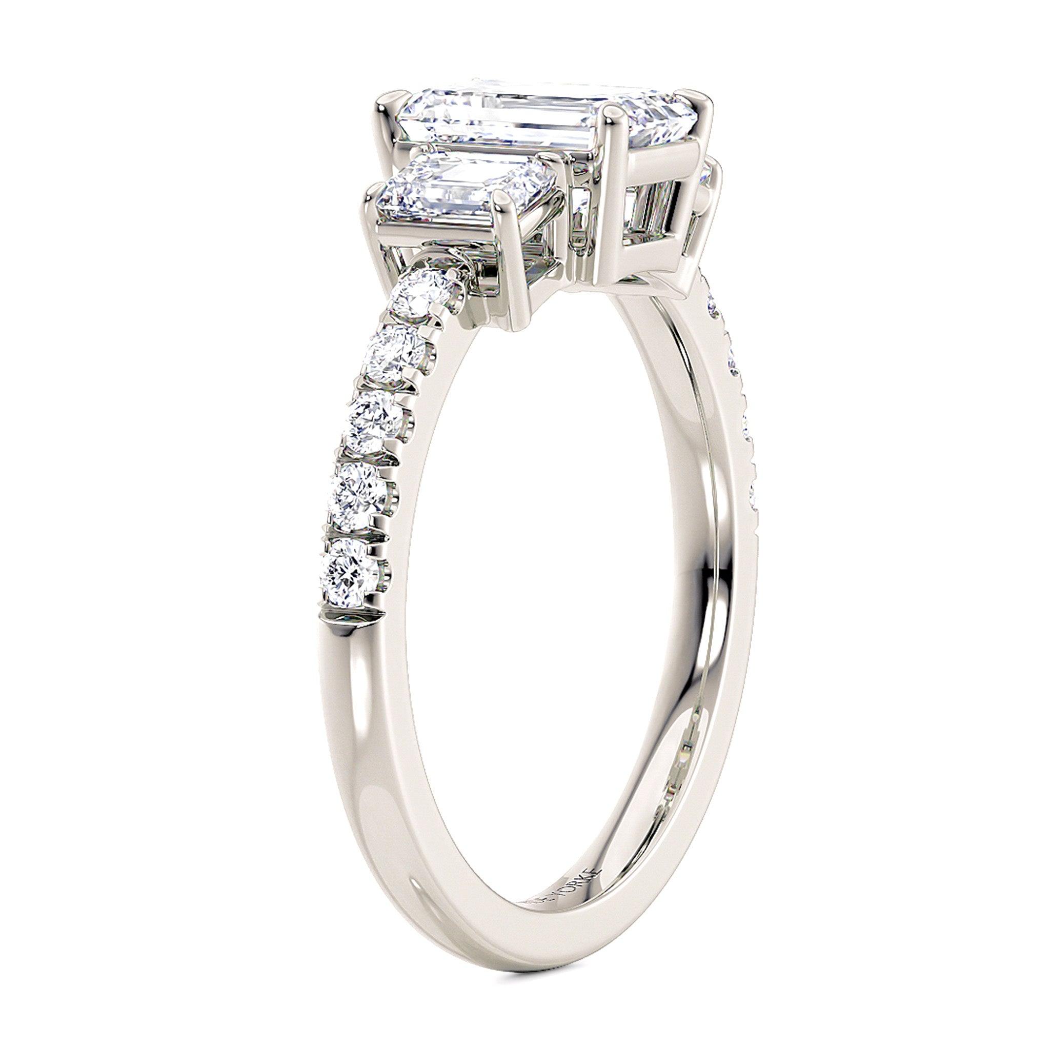 Adele emerald cut three diamond in platinum.  Side view showing 