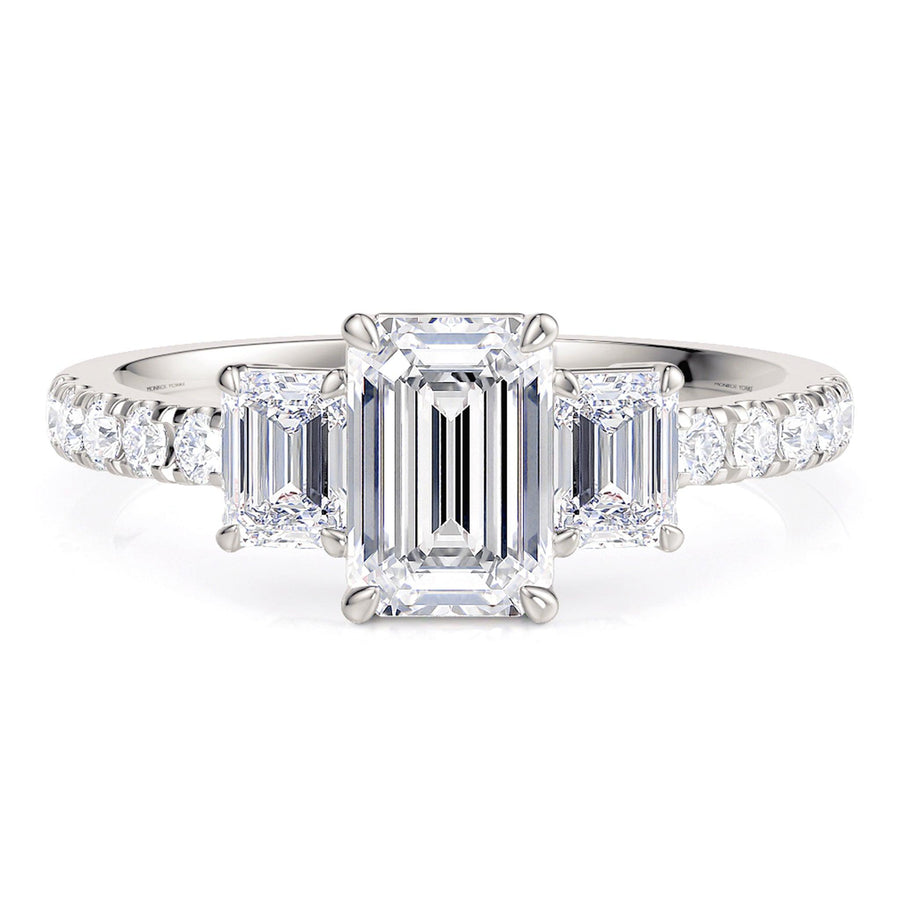 Aspen emerald cut diamond threes stone ring with diamonds on the band.  18 carat white gold. 