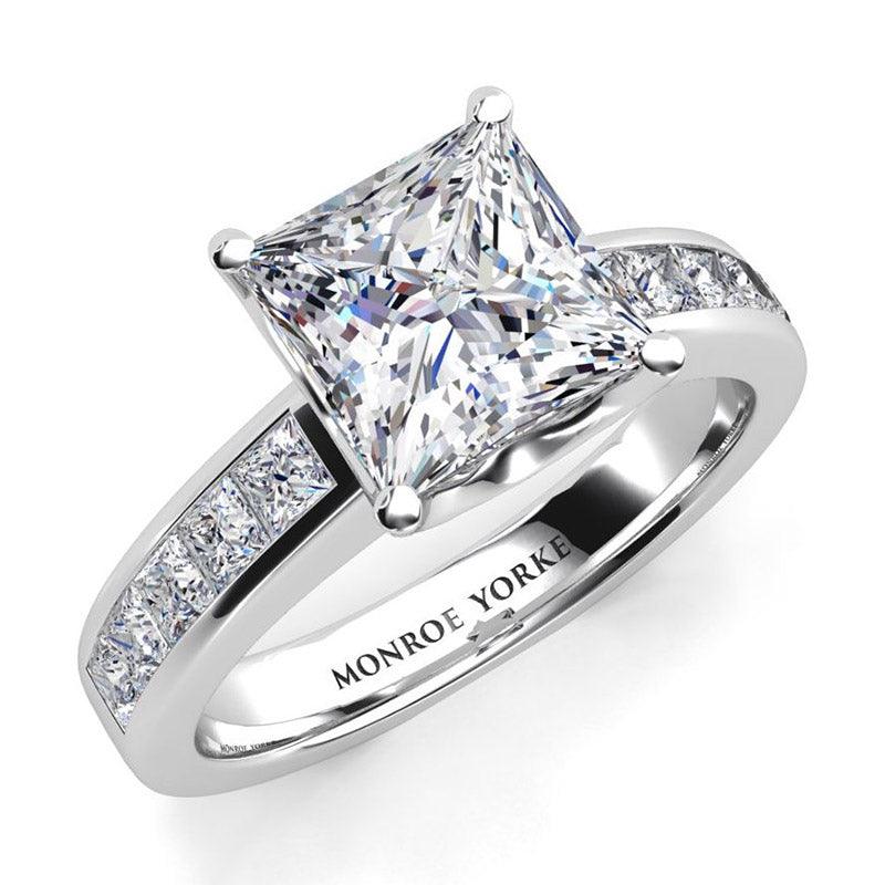 Albany Princess Cut Diamond Ring in Platinum.  princess cut centre diamond in a claw setting, with channel set princess cut diamonds on the band. Top view