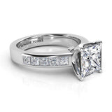Albany princess cut diamond ring in platinum.  Side view. princess cut diamond centre with channel set princess cut diamonds on the band. 
