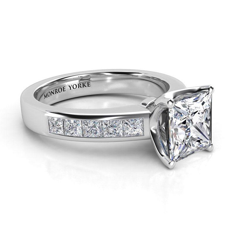 Albany princess cut diamond ring in platinum.  Side view. princess cut diamond centre with channel set princess cut diamonds on the band.  — view 3
