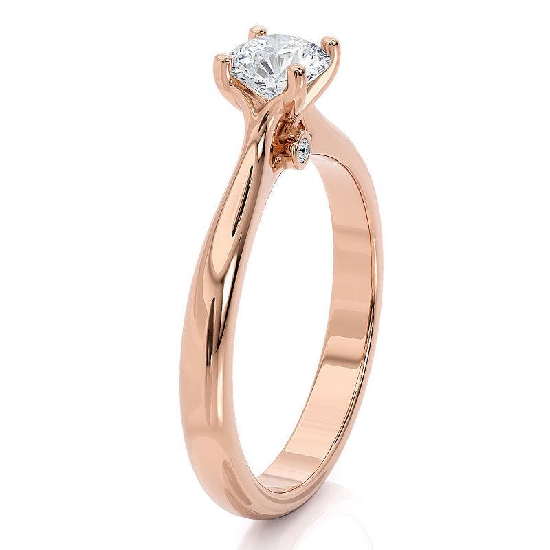 Asti - Rose gold solitaire diamond engagement ring. 4 claw setting. two diamonds set at the base of the centre setting.  Side view