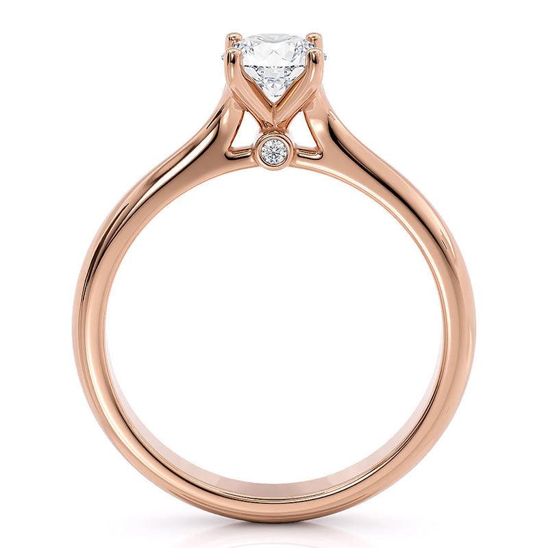 Asti - Rose gold solitaire diamond engagement ring. 4 claw setting. two diamonds set at the base of the centre setting.  Side view 2