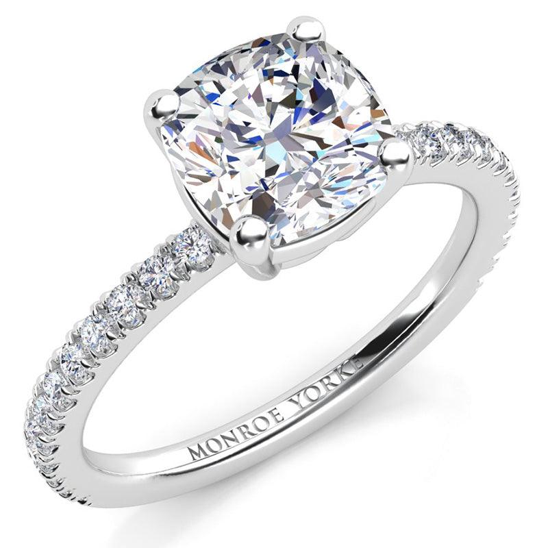 Blake - Centre GIA certified cushion cut diamond in a basket setting.  Diamonds set 2/3 of the way around the platinum band.