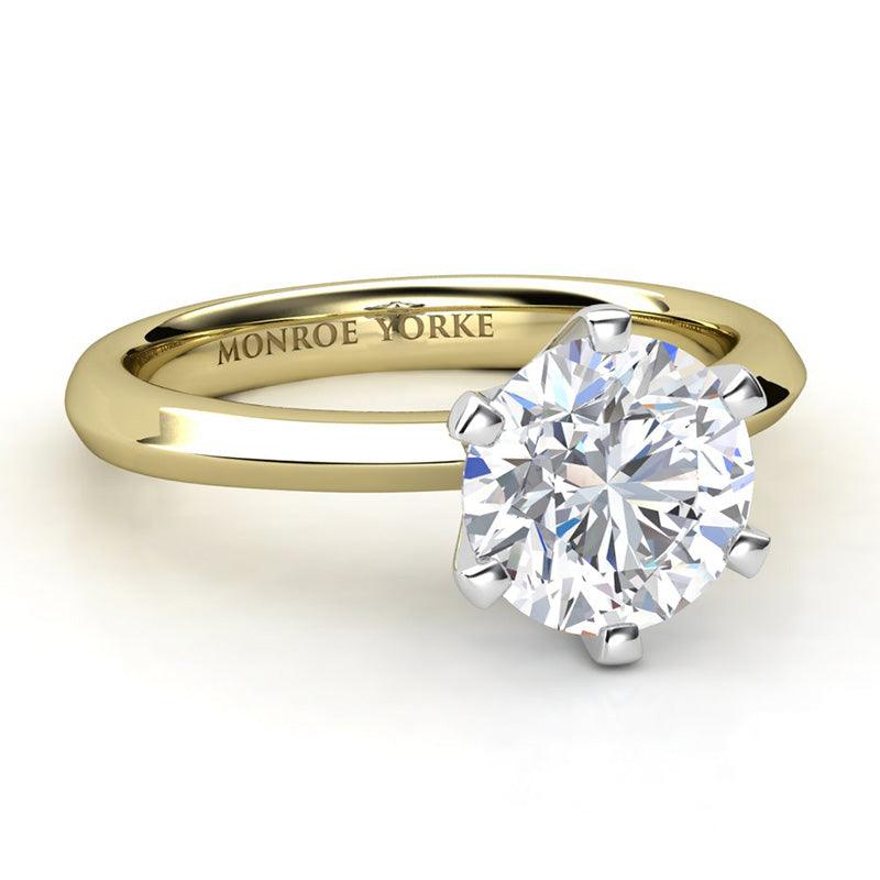 Six claw solitaire round diamond engagement ring. Yellow gold band and white fold centre setting. Calais side view