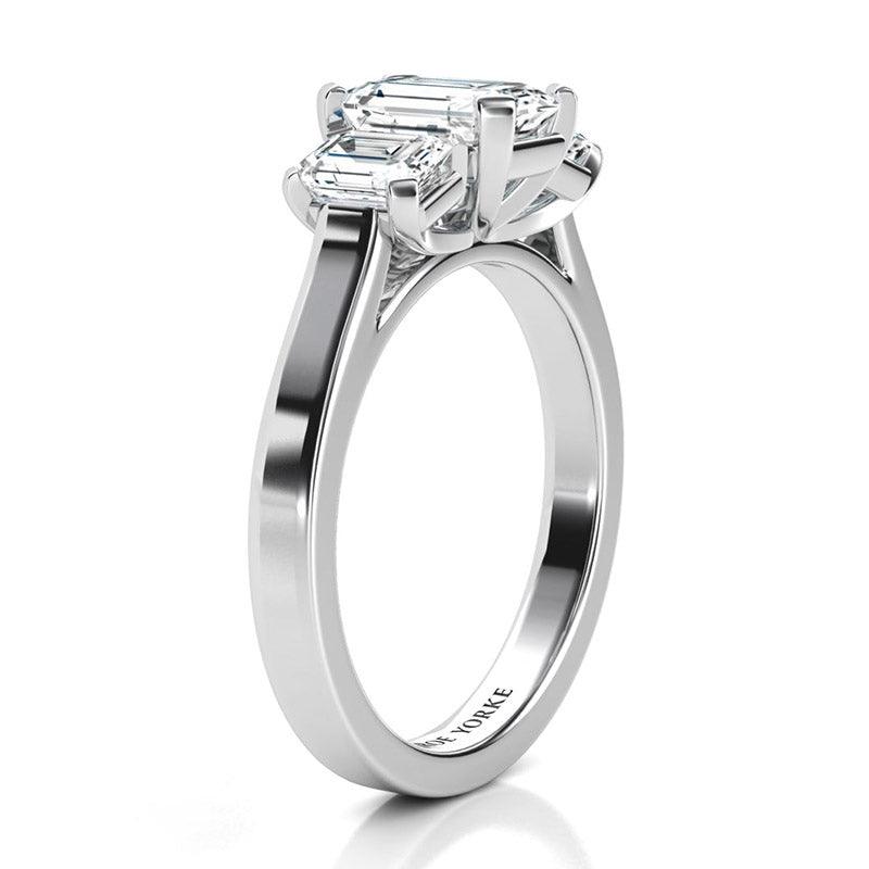 Calista Platinum - emerald cut three stone ring.  Side view showing the beautiful detail of the ring. 
