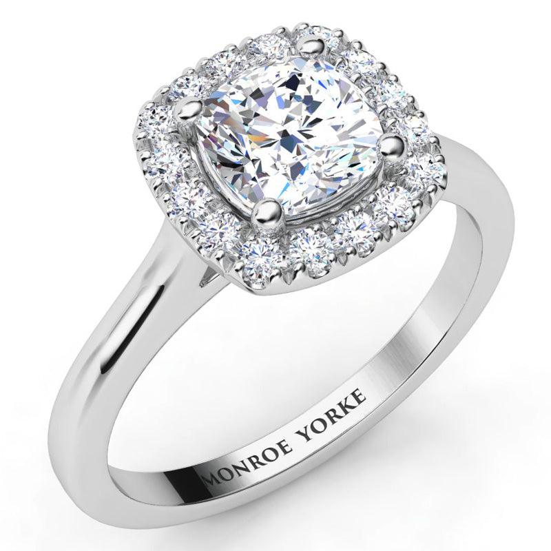 Carina - GIA certified cushion cut halo diamond engagement ring in platinum.  Halo of round diamonds set around the main cushion cut diamond.