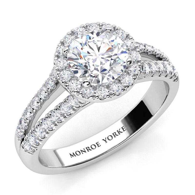 Ceduna - Round centre diamond engagement ring with a halo  and a diamond set split band. 18ct white gold. 