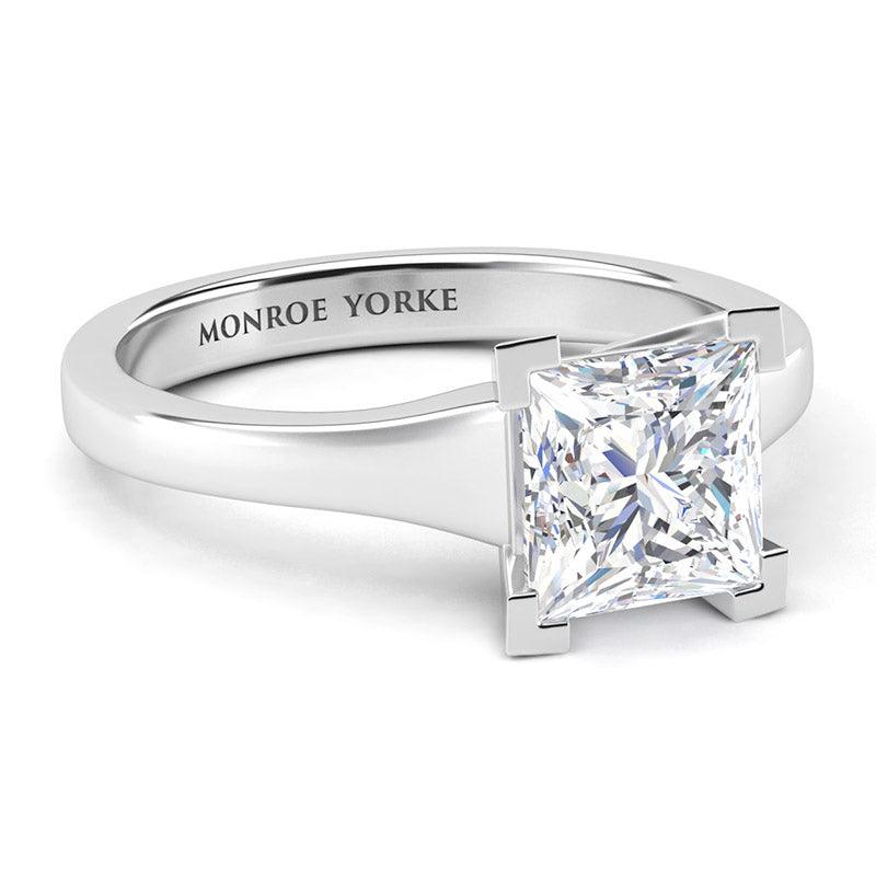 Princess cut solitaire diamond ring, centre v-claw setting. Chester in platinum. Side view showing tapered band — view 3