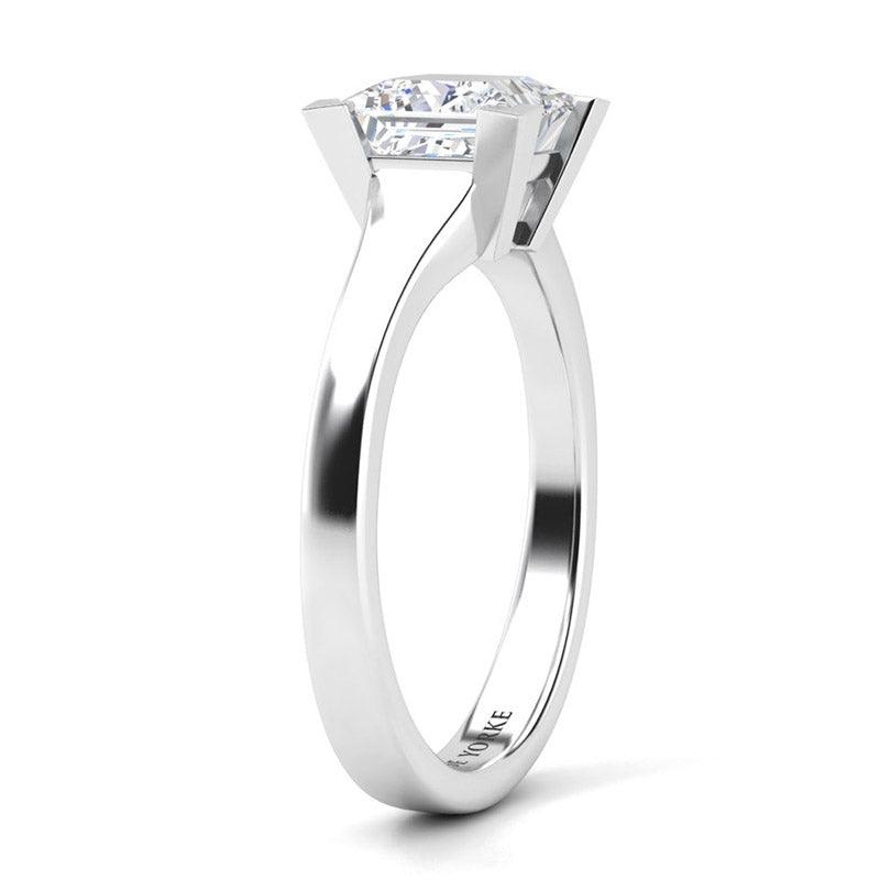 Princess cut solitaire diamond ring.  Chester in platinum. Side view showing tapered band and centre setting 