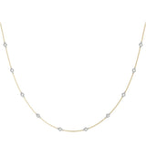 Diamond station necklace in yellow gold chain, white gold setting. 