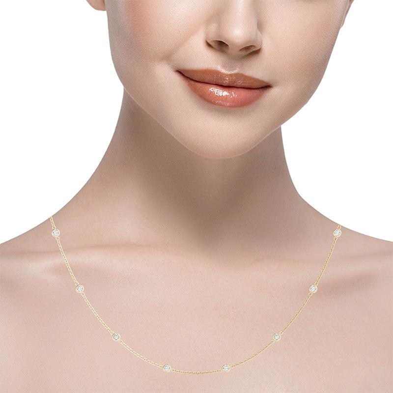 Dahlia station necklace in all yellow gold on neck