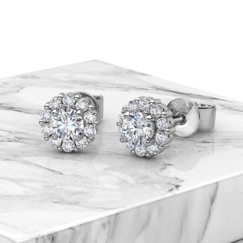 Daisy - diamond earrings. 0.20 carats centre diamond with halo of diamonds. Total 0.70 carats. 