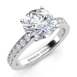 Danae - Round diamond ring in a 4 claw setting with pave set diamonds on the sweep up band. Platinum diamond ring.