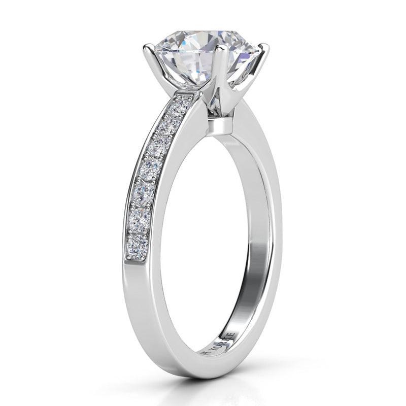 Danae - Round diamond ring in a 4 claw setting. Platinum diamond ring. Side view, showing pave set diamonds on the band and the beautiful centre setting.