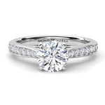 Four claw round brilliant cut diamond engagement ring with diamonds on the tapering sweep up band. Denver in platinum