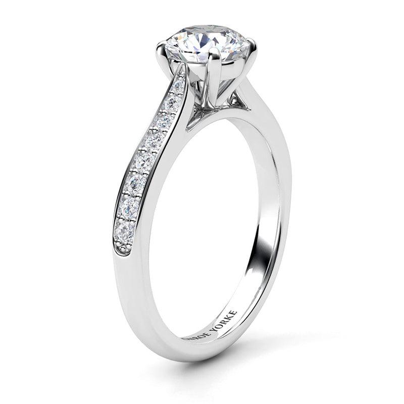 Denver in platinum, side view - Four claw round brilliant cut centre diamond and diamonds on the tapering sweep up band. 