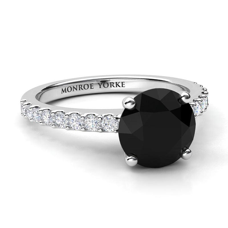Desir Black Diamond Engagement Ring with white diamonds on the band. White gold or platinum. Side view