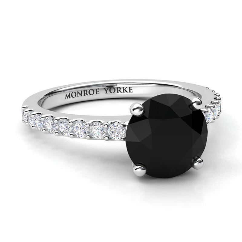 Desir - Black diamond ring in platinum.  Side view. Centre round black diamond 1.70 carats. Centre diamond in a 4 claw setting