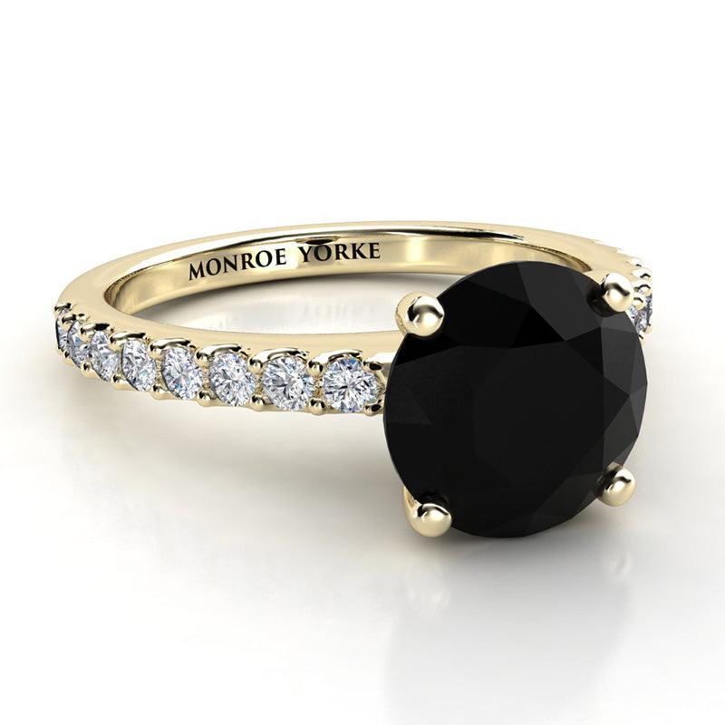 Desir - Gold black diamond ring - Front-Side View. 1.50 carat round black diamond centre . White diamonds down the band.  