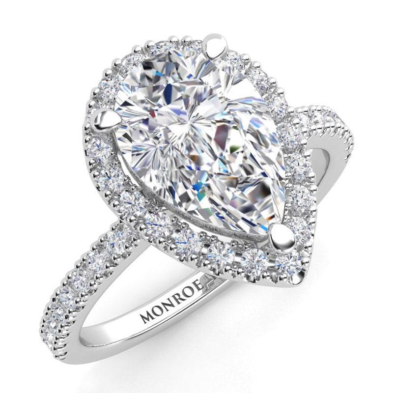 Pear shape cut diamond halo engagement ring in platinum. 