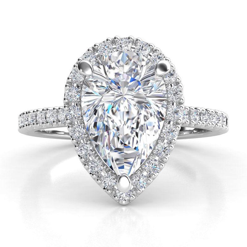Dune pear shape cut diamond halo engagement ring with diamonds on the band, created in platinum. 