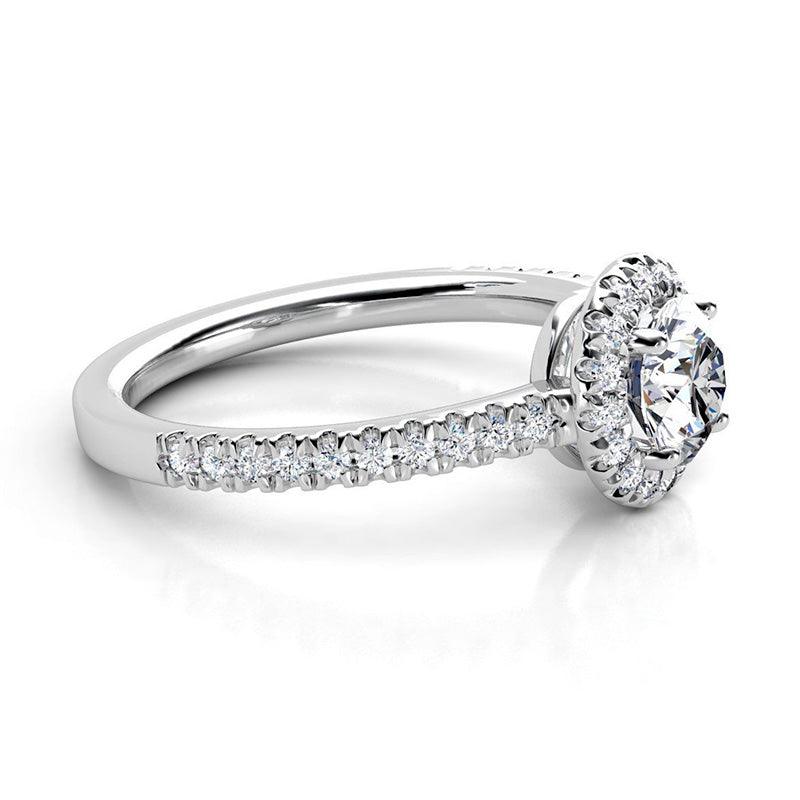 Ecco - round diamond halo ring with a low centre setting. Diamonds on the band. 18ct white gold 