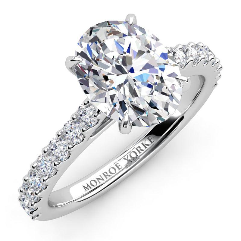 Elodie Oval Cut Diamond Engagement Ring in platinum with round brilliant cut diamonds on the Band.