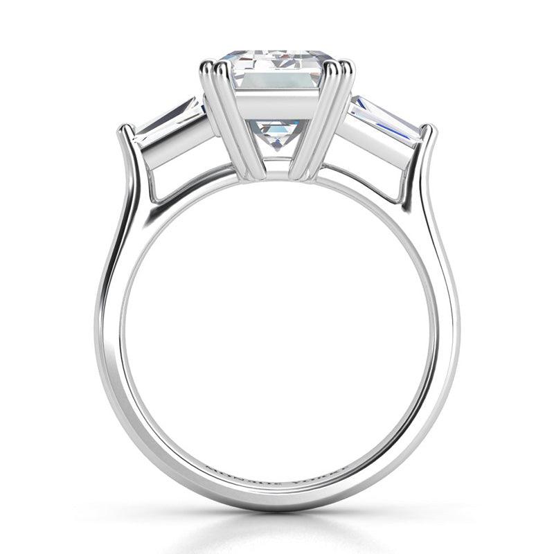 Envy Platinum - Emerald cut diamond and tapered cut baguette three stone ring. Side view showing centre and side diamond setting. 