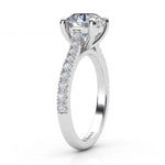 Enya - Side view. GIA certified round diamond engagement ring in a 4 claw setting with diamonds on the sweep up band. 18ct white gold