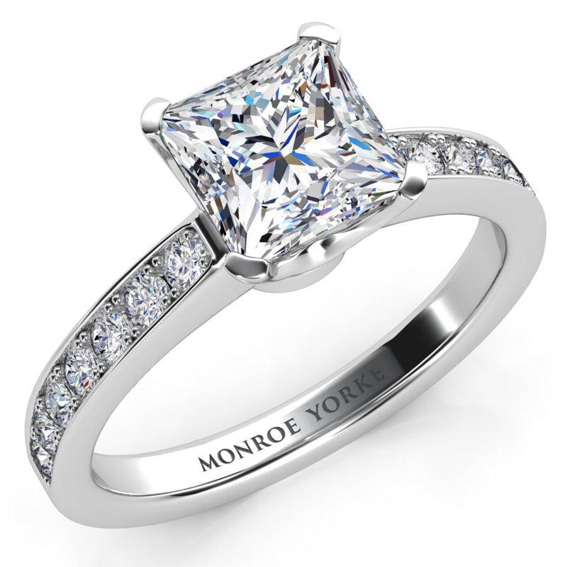 Fifth Avenue - square princess cut diamond engagement ring with round diamonds on the band. Platinum band and setting
