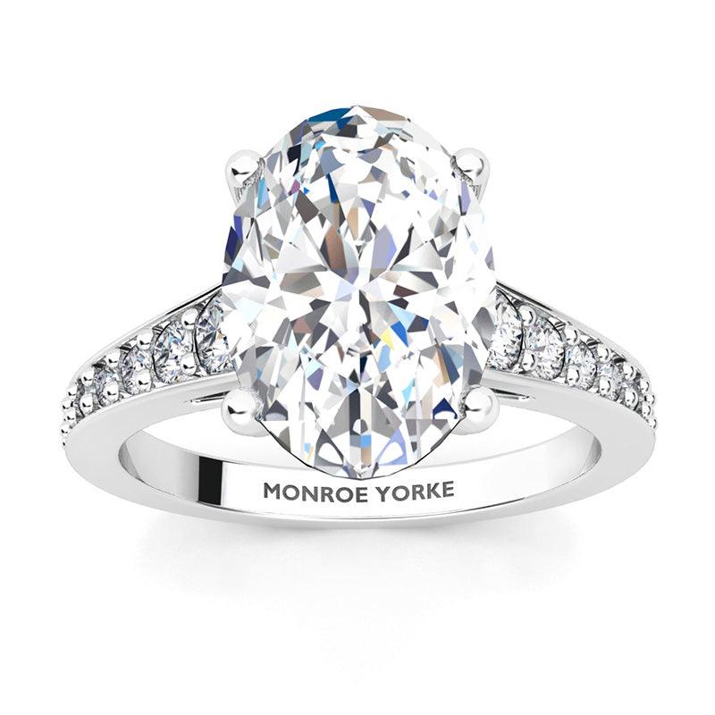 Finley engagement ring in white gold.  Centre premium oval cut diamonds in a 4 claw setting.  Graduated band with diamonds