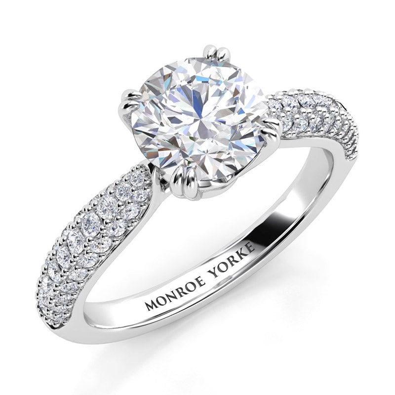 Harper - Pave set diamond ring in platinum. Centre GIA certified round diamond in a 4 claw setting, double claws. pave set diamonds in 3 rows. 