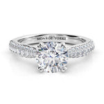 Harper - Front view. Diamond ring in platinum. Centre GIA certified round diamond in a 4 claw setting, double claws. pave set diamonds in 3 rows on the band.