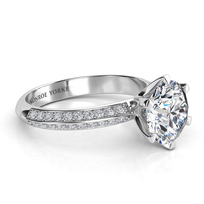 Juliet White Gold.  Round diamond engagement Ring in a six claw setting.  Two rows of side or shoulder diamonds. Side view showing beautiful 6-claw centre setting and pave set diamonds on the band