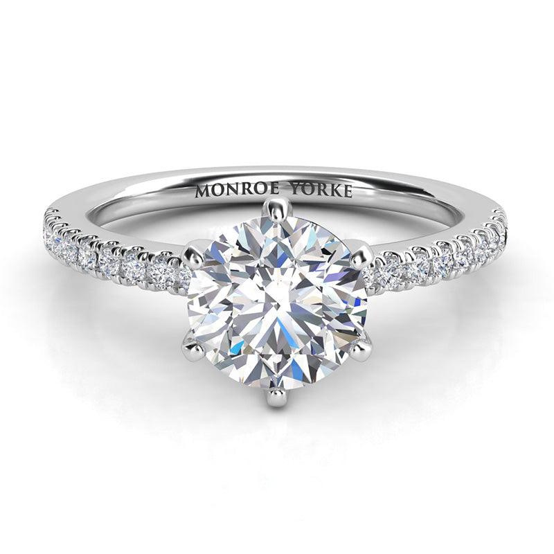 Diamond engagement ring in platinum with side diamonds. Centre diamond in a six claw setting. 