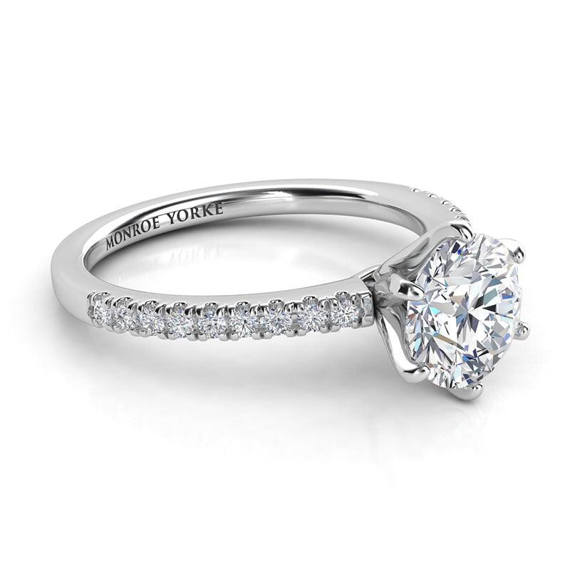 Diamond engagement ring in platinum with Side diamonds. Centre six claw setting