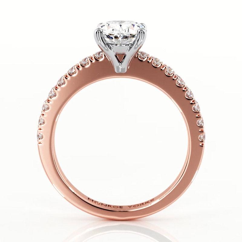 Kendall oval diamond engagement ring in rose gold.  Side view showing the beautiful centre setting and diamonds on the band 