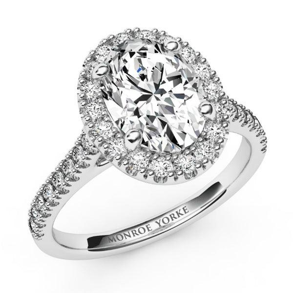 Laurel in platinum: Oval cut diamond halo engagement ring,  diamonds on the sweep up band. 