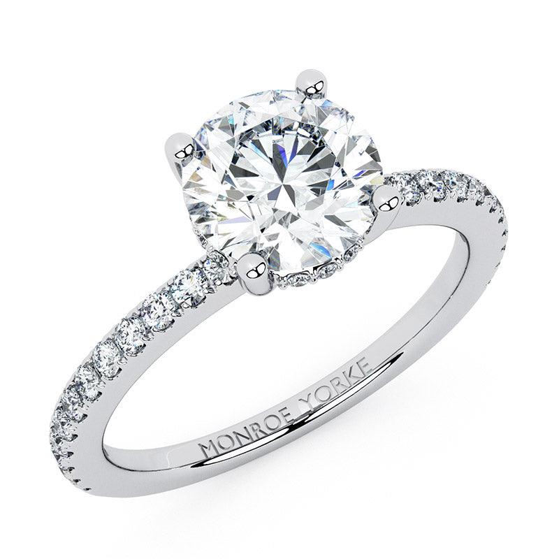 Liliana (top view) GIA certified, round diamond engagement ring with a hidden halo. Diamonds on the band.  18ct white gold or platinum