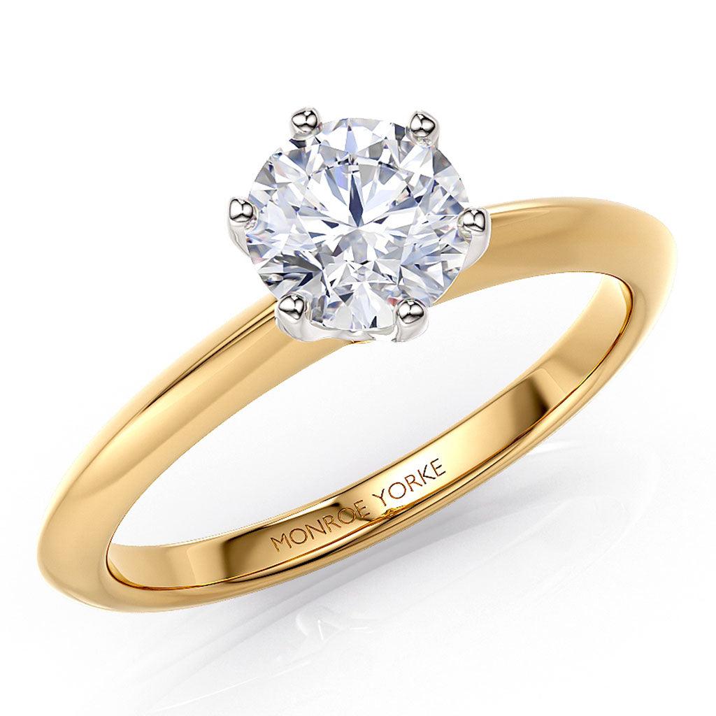 Love - premium lab grown round diamond on a gold solitaire ring.  Centre 6 claw setting in white gold / silver.  Gold band with a knife edge. 