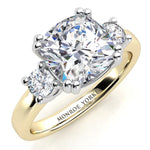 Meghan Markle three diamond engagement ring. Centre cushion cut diamond with two round diamond on either side