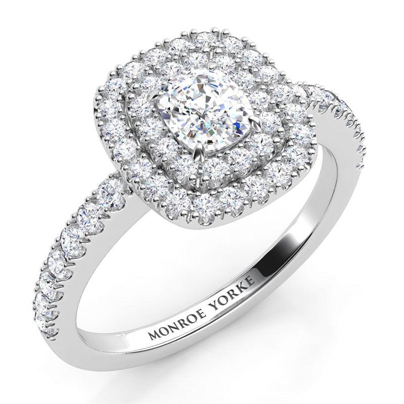 Norah in platinum - centre cushion cut diamond in a double halo setting with diamonds on the band.