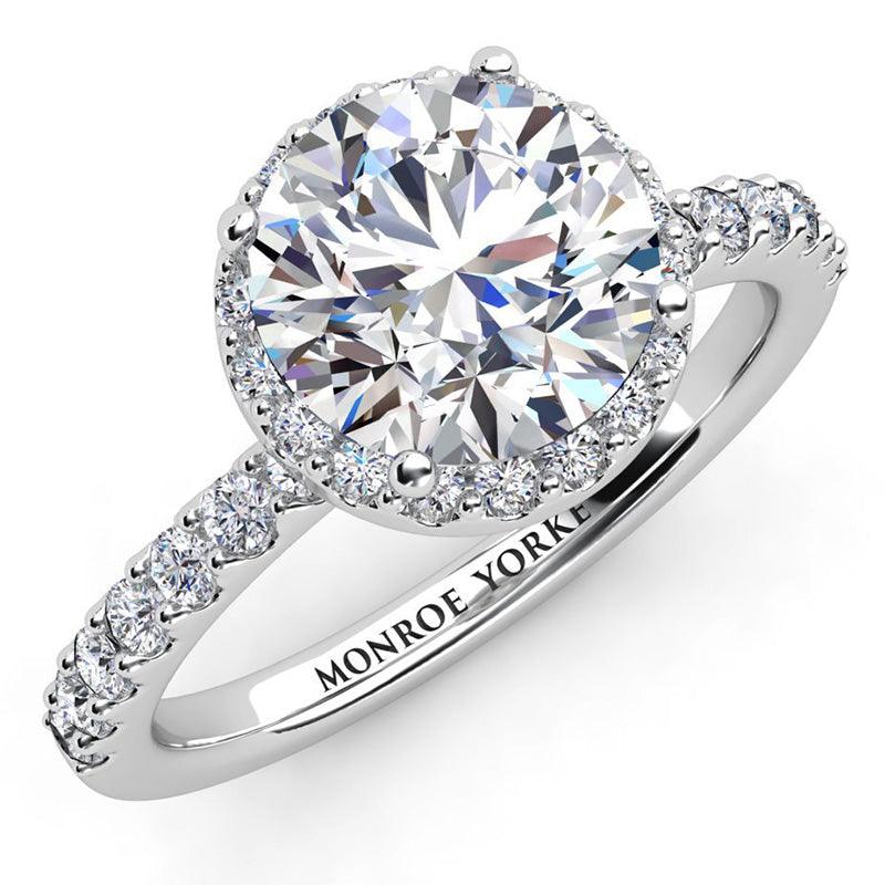 Orion - Unique diamond Halo Ring in platinum, with halo set just under main diamond and diamonds on the band