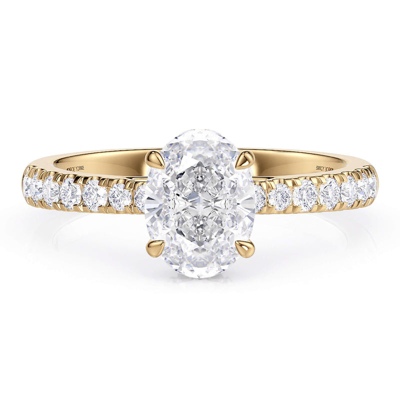 Oval diamond engagement ring in yellow gold.  Hidden halo under the main diamond around the girdle of the diamond.  Centre diamond in a 4 claw setting 